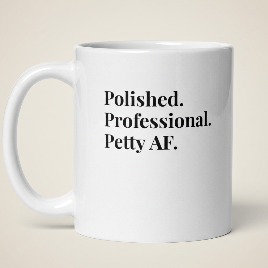 White mug with text 'Polished. Professional. Petty AF.' on a beige background