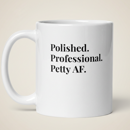 White mug with text 'Polished. Professional. Petty AF.' on a beige background