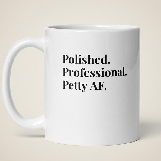 White mug with text 'Polished. Professional. Petty AF.' on a beige background