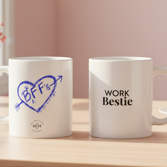Two mugs with 'BFF's' and 'WORK Bestie' text on a wooden surface.